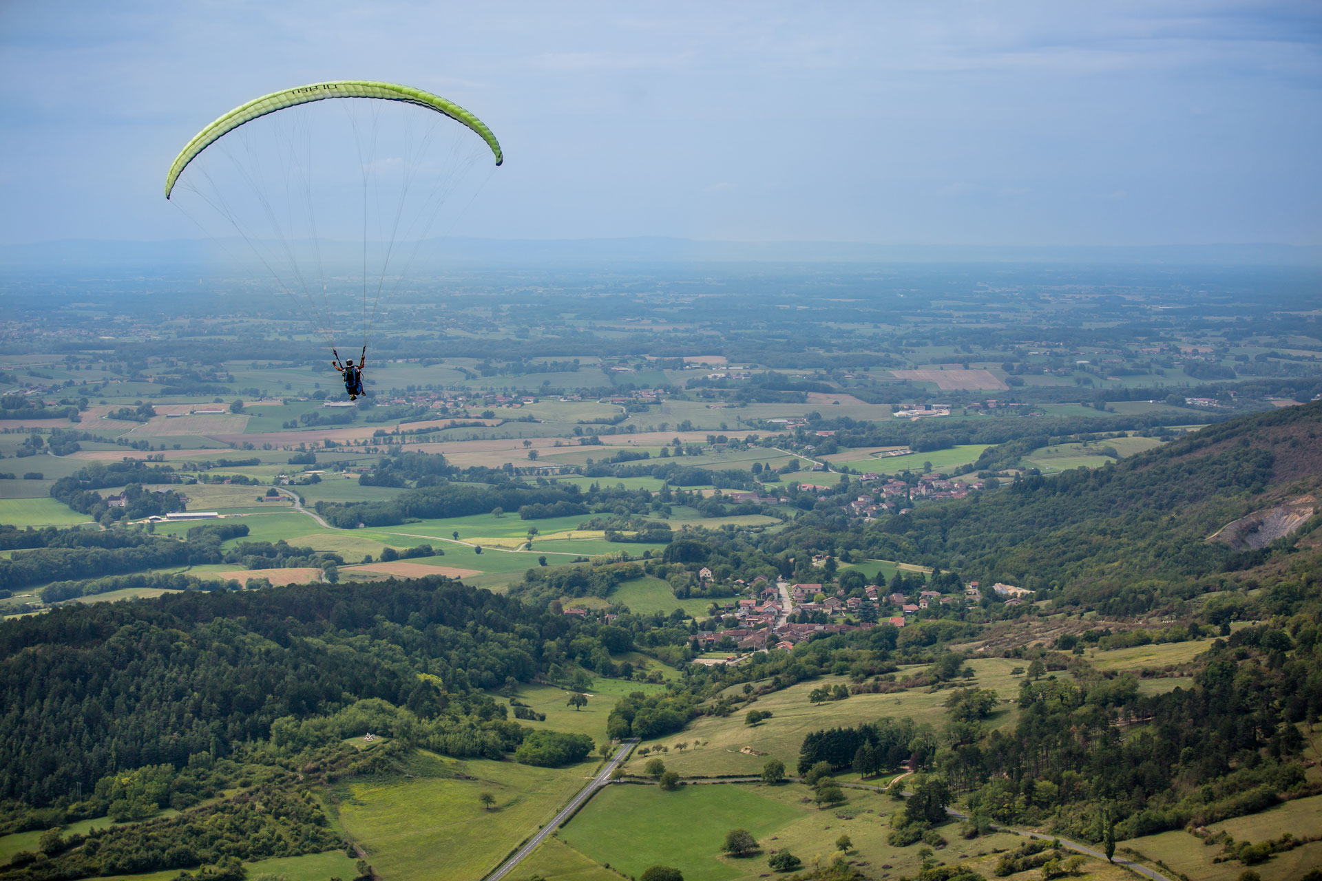 Aerial view of the Revermont, an area located to the east of Bourg-en-Bresse in the heart of the Grand Bourg Agglomération territory, and made up of the first foothills of the Jura Mountains where paragliding enjoys an exceptional setting.